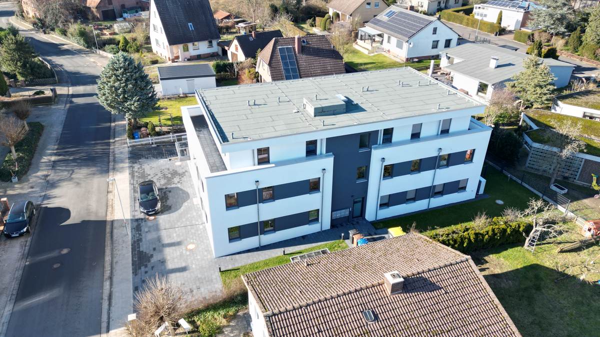 Straßenseite mit Zufahrt und Stellplätzen